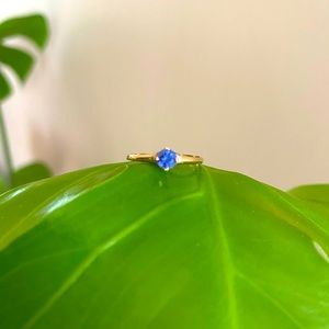 Vintage, tiny gold ring with small blue stone.